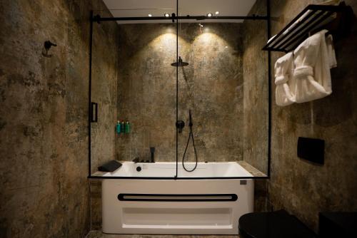 a bathroom with a shower and a white sink at Carpe Diem Hotel in Borsh