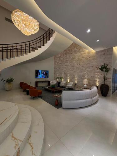 a large living room with a couch and a tv at Grand Maison Hotel in Porto Velho