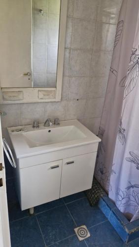 a bathroom with a white sink and a mirror at Cabañas Mateo in Villa Pehuenia