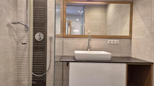 a bathroom with a sink and a shower at Appartement HARRIE by Miha in Westendorf