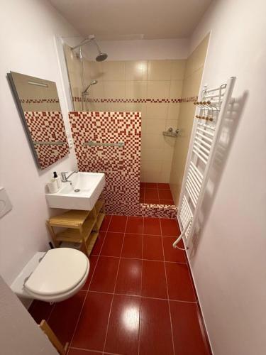 a bathroom with a white toilet and a sink at Apartmán Na Hvězdné Mýtince in Jeseník