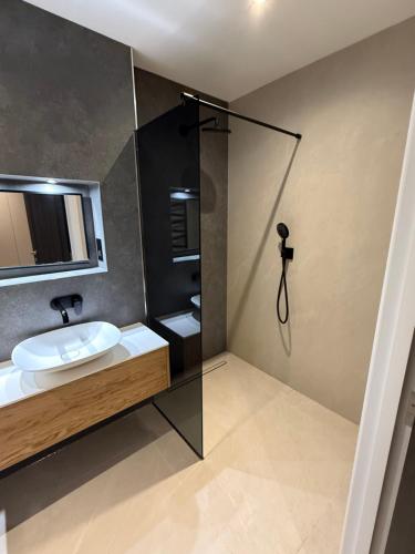 a bathroom with a sink and a shower at The North Wing in Stotfold