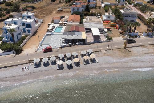 an aerial view of a beach with chairs and umbrellas at Laza Beach in Skala