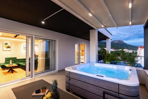 a jacuzzi tub in a room with a view at Penthouse Petar in Kastel Stari
