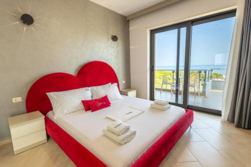 a bedroom with a heart shaped bed with towels on it at Britannia Resort & SPA in Vlorë