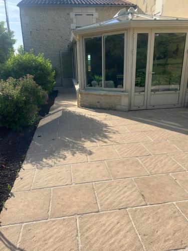 a brick walkway leading to a patio of a house at domaine grangieras in Château-lʼÉvêque