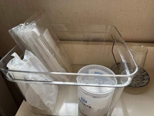 an empty drawer with a container in a refrigerator at Kouan 功庵 in Matsuyama