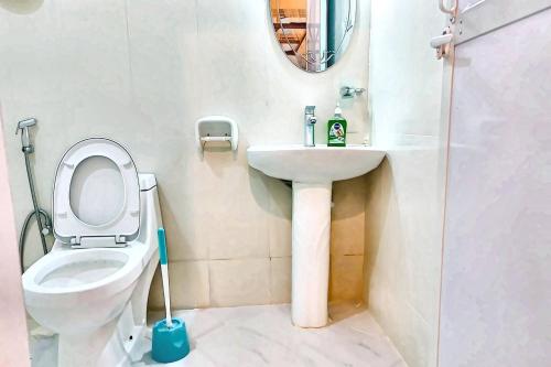 a bathroom with a toilet and a sink at Uroa Beachfront Apt Direct Sand in Uroa