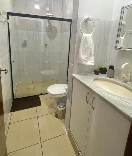 a bathroom with a shower and a toilet and a sink at Residencial Mandi in Guaíra