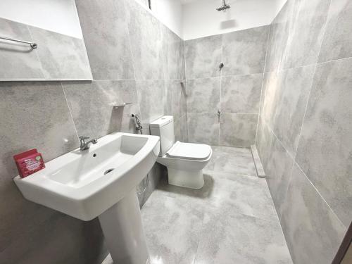 a bathroom with a sink and a toilet at Villa 87 - Anuradhapura in Anuradhapura