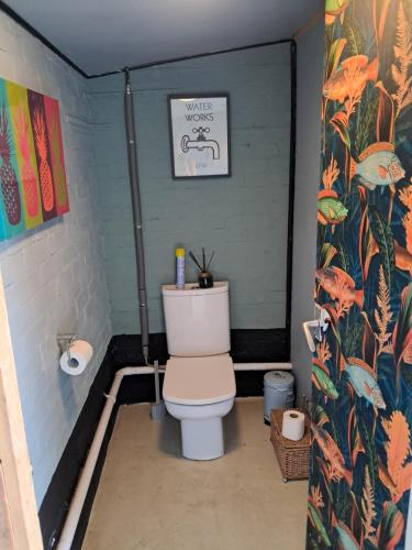 a bathroom with a white toilet in a room at The Old Waterworks - Venus Bell Tent in Clare