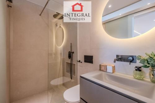a bathroom with a sink and a toilet and a mirror at La Braveta in Sant Antoni de Calonge