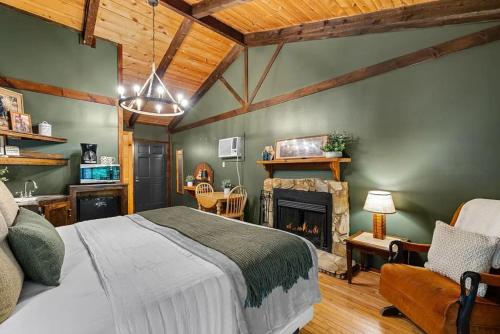 a bedroom with a bed and a fireplace at The Lost Compass in Sautee Nacoochee
