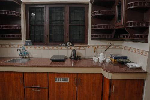 a kitchen with a sink and a counter top at The Villa Mahogany in Trivandrum