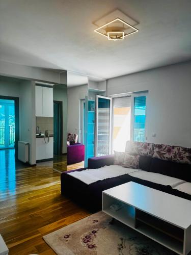 a living room with a bed and a couch at Apartman Lala in Sarajevo