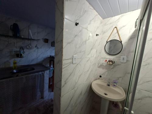 a white bathroom with a sink and a mirror at Casa de Férias Carioca in Rio de Janeiro