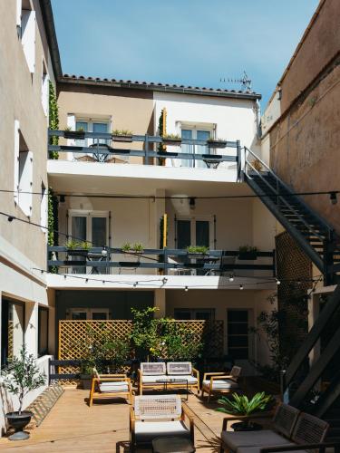 an outdoor patio with chairs and tables in a building at Hotel de Paris in La Rochelle