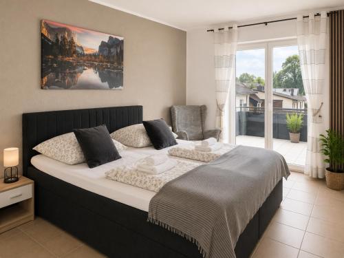 a bedroom with a large bed and a large window at Rheinview Sunset in Urbar in Urbar