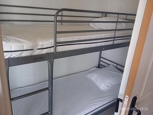 a couple of bunk beds in a room at les pieds dans l'eau 2 - Piscine chauffée in Le Barcarès