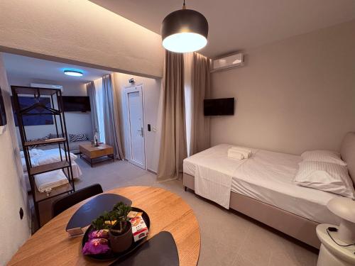 a bedroom with a bed and a table in a room at Annasa Suites 2 in Mángana