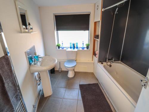 a bathroom with a sink and a toilet and a tub at Number 3 Old Boston Road in Lincoln