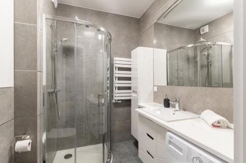 a bathroom with a shower and a sink at Warsaw Concierge Gocławek in Warsaw