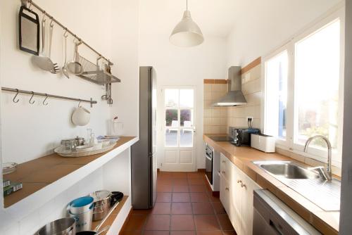 a large kitchen with a sink and a window at Casa Rita in San Ferrán de ses Roques