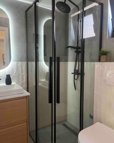 a bathroom with a shower and a sink at Villa Ruj Retreat Deliblatska Peščara in Šumarak