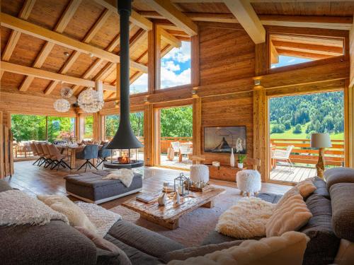 a living room with couches and a fireplace at Chalet Alti - OVO Network in Le Grand-Bornand
