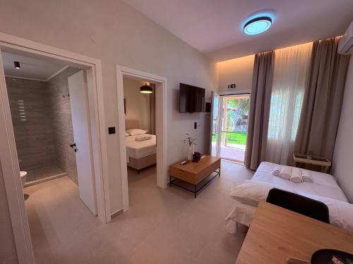 a hotel room with a bedroom with a bed and a bathroom at Annasa Suites 1 in Mángana