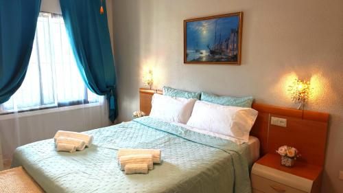 a bedroom with a bed with two towels on it at Tango Andaluz - Sunset Ritual Incl in Fuengirola