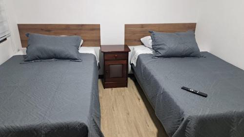 two beds sitting next to each other in a room at Panul Ovalle in Panulcillo