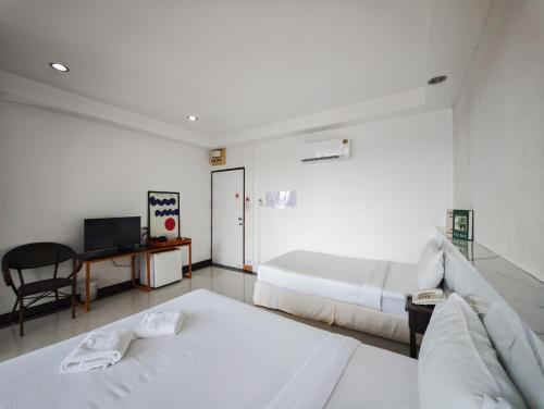 a hotel room with two beds and a desk at Raya Buri Resort Kanchanaburi in Ban Hin Hak