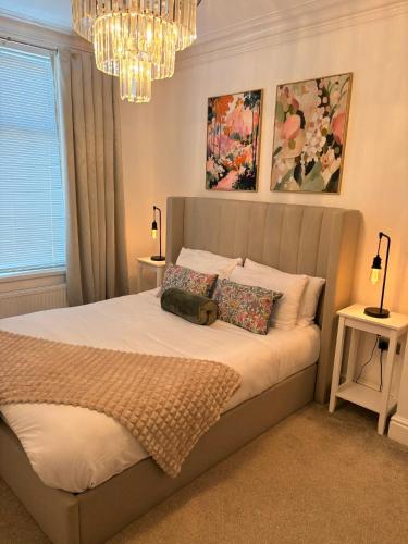 a bedroom with a large bed with two night stands at Coastal Apartments No 2 in Seaham