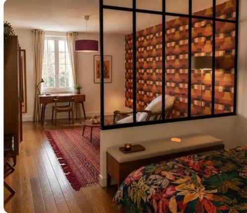 a bedroom with a bed with a large mirror above it at Grand gîte convivial proche de Dijon in Marey-sur-Tille