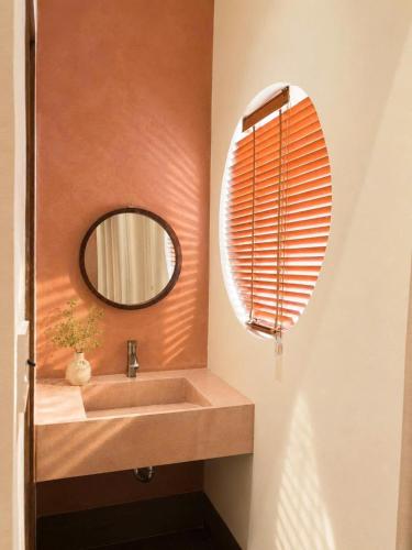 a bathroom with a sink and a mirror at Shine Home in Hue