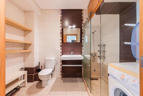 a bathroom with a toilet and a sink and a shower at Ola Blanca - Pool - Garden in Dar Hamida