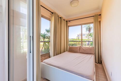 a bedroom with a bed and a window at Ola Blanca - Pool - Garden in Dar Hamida