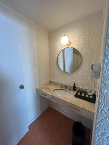 a bathroom with a sink and a mirror at ZAG Coliving Punta del este in Punta del Este