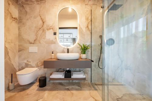 a bathroom with a sink and a mirror at Balsamia Boutique Apartments in Podčetrtek