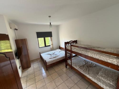 a room with two bunk beds and a window at ApartHotel Fahria Velipoje in Velipojë