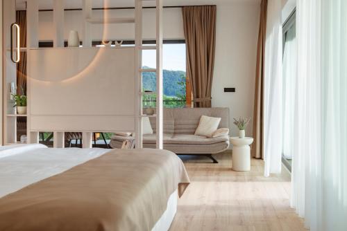 a bedroom with a bed and a couch at Balsamia Boutique Apartments in Podčetrtek