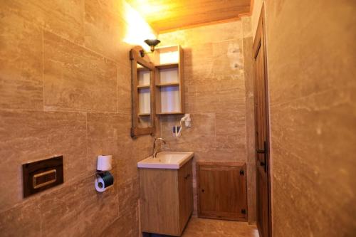 a bathroom with a sink and a mirror at Süleyman Cappadocia - Hot Air Balloon View in Göreme