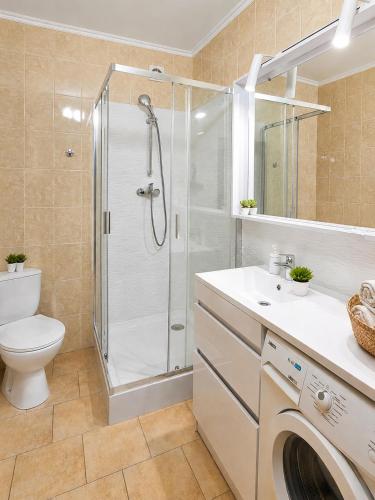 a bathroom with a shower and a toilet and a sink at Mountain View "Green Apartment" in Mukacheve