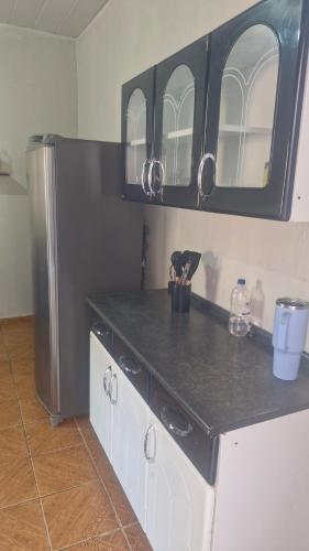 a kitchen with a counter top and a refrigerator at Apartamento in Jericoacoara