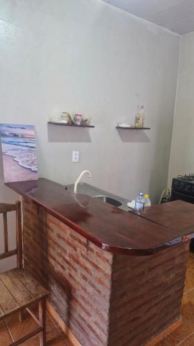 a kitchen with a wooden counter top and a sink at Apartamento in Jericoacoara