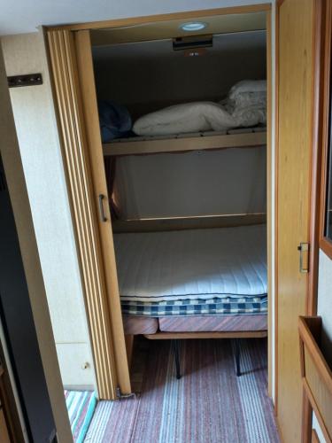 a small closet with a bed in it at Stetind Skicamp in Lyngen