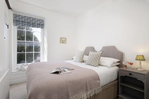 a bedroom with a large bed with a window at The Haven in Chipping Norton