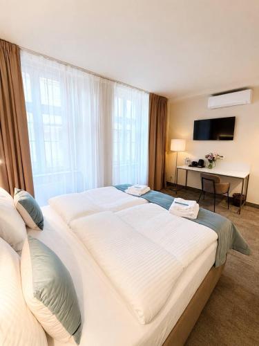 a large white bed in a hotel room at Oysters & Bubbles Gastro Rooms Rynek Square in Poznań