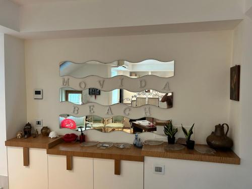 a mirror on the wall in a living room at movida beach in Bari